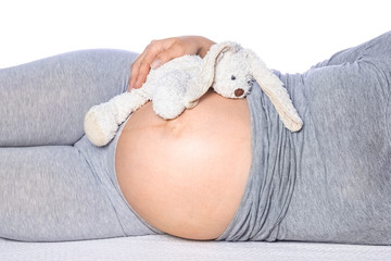 Happy pregnant girl lies on white background