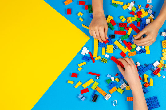 Vilnius, Lithuania - February 23, 2019. Children hands play with colorful lego blocks on the table