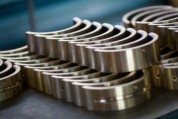 Dismantled locomotive driver. Engine parts lie on a table in a factory