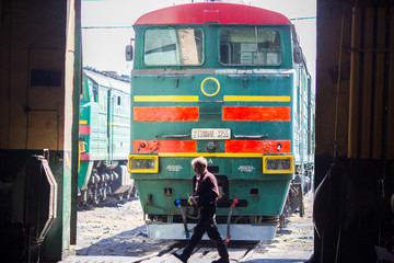 Ussuriysky Locomotive Repair Plant. An old locomotive car is being repaired in a railway depot