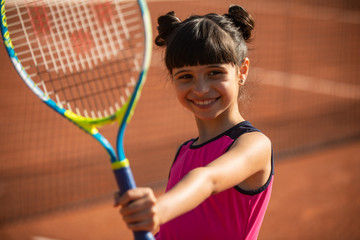 portrait of a smiling and happy young tennis player