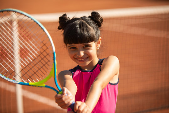 portrait of a smiling and happy young tennis player