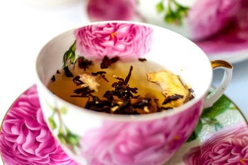 Cup of tea. Large tea leaves in a Cup. Large-leaf tea with fruit. Tea party.