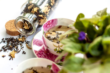 Cup of tea. Large tea leaves in a Cup. A can of tea. Large-leaf tea with fruit. 