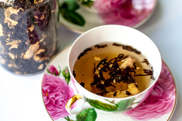 Cup of tea. Large tea leaves in a Cup. A can of tea. Large-leaf tea with fruit. 
