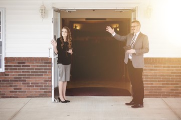 Male and female church members standing at the church doors