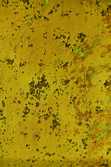 Structured surface of aged yellow rusty wall with peeling paint
