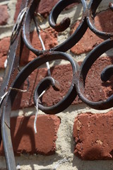 A closeup of rusted iron against brick