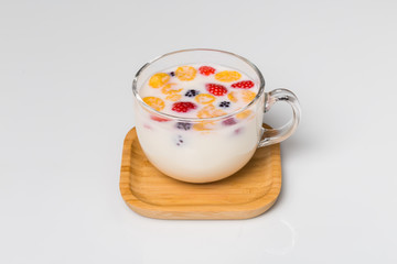 A glass of milk and fresh fruits.