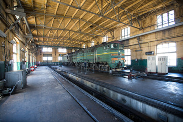 Ussuriysky Locomotive Repair Plant. An old locomotive car is being repaired in a railway depot