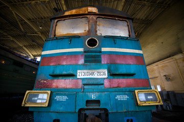 Ussuriysky Locomotive Repair Plant. An old locomotive car is being repaired in a railway depot