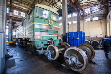 Naklejka premium Ussuriysky Locomotive Repair Plant. An old locomotive car is being repaired in a railway depot