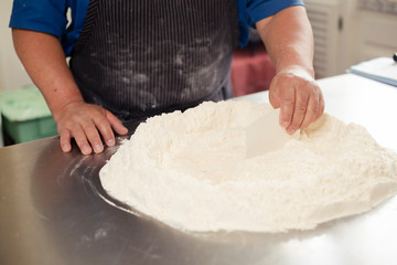 Man hands on flour bowl - latin man keeping his hands on the table with flour