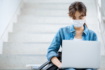 student woman working on laptop at stairs university campus wear mask
