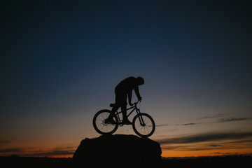 Obraz na płótnie Canvas silhouette of a man with a bicycle