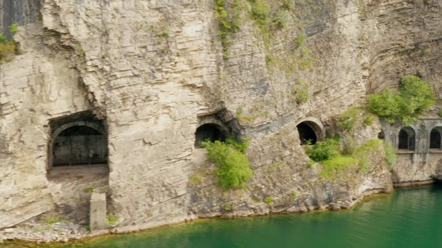 Aerial view of tunnel Grumo with arches in a rock near Como Lake. Cars moving in tunnel, near Olcio, Italy