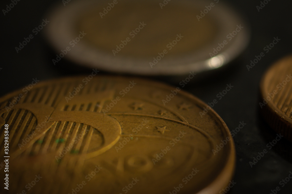 Wall mural close up on two coins on a black table. selective focus.