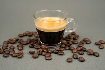 close up of a mug of coffee scattered coffee beans