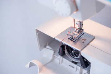 Sewing machine close up. Maintenance of a modern sewing machine