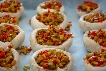Stuffed mushrooms on baking paper. Homemade baked stuffed Portobello mushrooms, homemade baked stuffed mushrooms