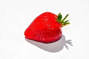 Red bright fresh strawberry closeup on the white background. Isolated berry, berry shadow.