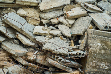 Breakwaters stand on the sea shore near the stone wall. The lattice of concrete.