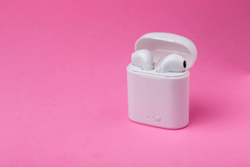 Wireless headphones and charging case. White headphones wireless earphones. Earphones for new modern phone.