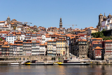 Colorful houses of Porto Ribeira, traditional facades, old multi-colored houses with red roof tiles...