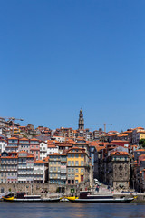 Naklejka premium Colorful houses of Porto Ribeira, traditional facades, old multi-colored houses with red roof tiles on the embankment in the city of Porto, Portugal. Unesco World Heritage.