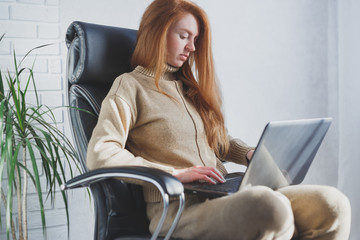 Young caucasian woman using laptop working from home, freelancer, social distancing and remote work