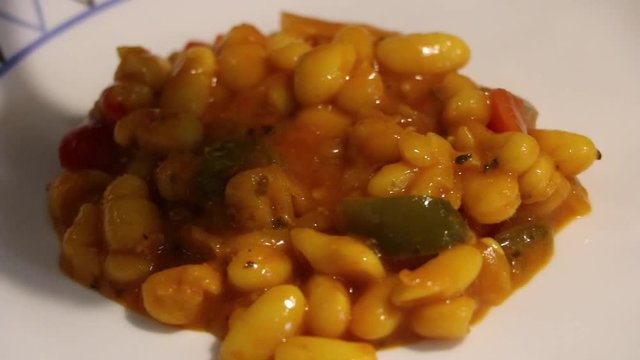 Presenting the Meatballs with white beans in vegetables on a plate