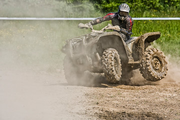 ATV Quad rides fast on big dirt and makes splashes of dirty water, quad racing,  ATV 4x4.  ATV rider.