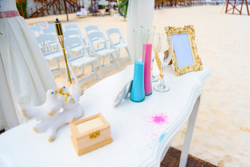 White table for a wedding ceremony with decorations on the seashore.