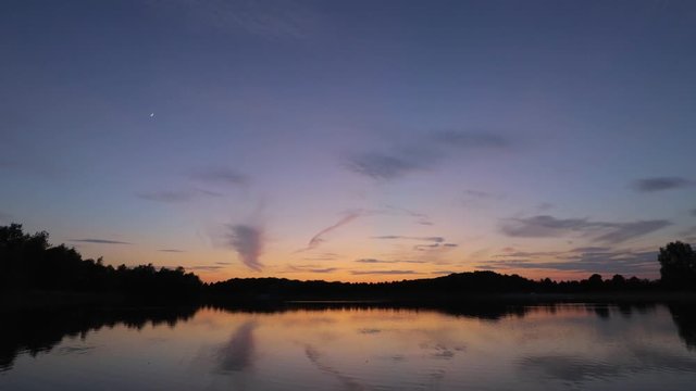 Cinemagraph - clouds and sunset over lake, time-lapse.
