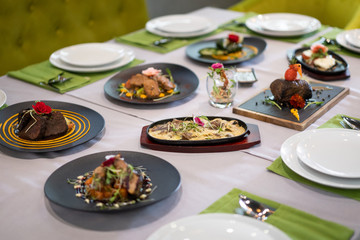 many different dishes arranged on the table view of the chef in a restaurant