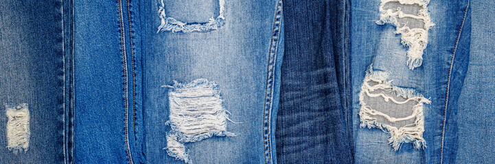 Torn Denim jeans pants collection. Lots of ripped blue trousers. Trendy fashion design background 