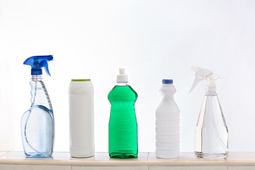 Household cleaning products on white background.