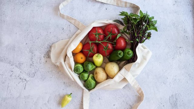 grocery vegan product gathering on the reusable bag with the mobile phone green screen interface on flat lay design. fresh vegetable online shopping and e commerce .stop motion video