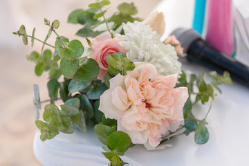 Scenery of flowers of white and pink roses on a wedding arch.