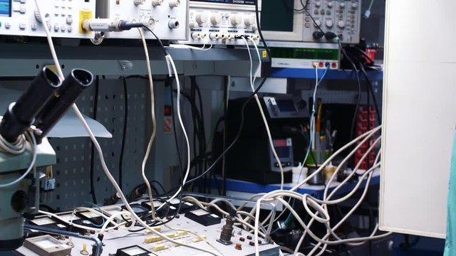 Male lab assistant switches plugs in device.