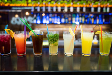beautiful photo of many different cocktails prepared by a bartender at the bar