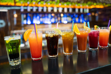 beautiful photo of many different cocktails prepared by a bartender at the bar
