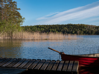 Fototapeta premium Red fishing boat in lake