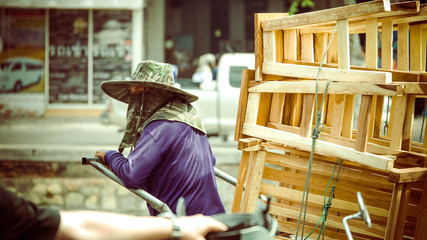 Man in purple shirt pulling stacks of crates