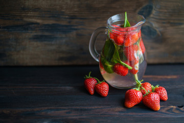 Summer refreshing strawberry lemonade. Vitamin drink. Homemade infused water with kiwi and cucumber. Tasty cold seasonal beverage