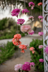 Scenery of flowers of white and pink roses on a wedding arch.