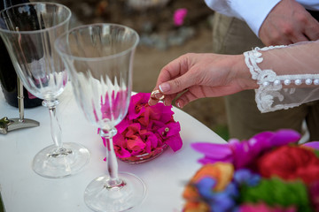 The bride takes out rings from flower petals.