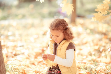 Angry little mixed girl portrait outdoors.