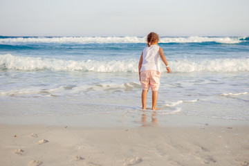 happy  little girl have fun and joy time at beautiful beach