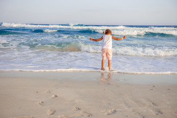 happy  little girl have fun and joy time at beautiful beach
